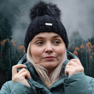 Stylish black women’s winter beanie made of alpaca wool with pom-pom